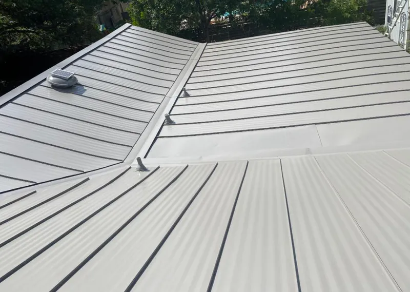 Solar attic fan installed on a metal roof for Roof Ventilation in Sky Lake